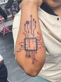 a woman with a tattoo of a circuit board